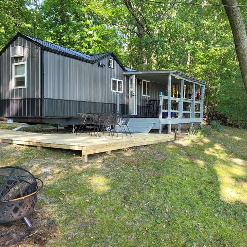 Exterior:  the front of the house showing the deck and bonfire ring.