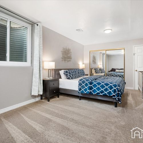 The downstairs master bedroom offers ultimate convenience with a king size bed, a crib, and air mattress, perfect for small families.