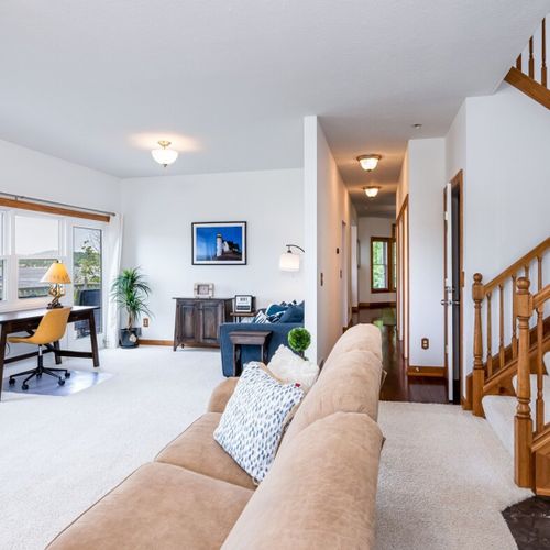 Living room:  the home has a large and lovely living room with comfy furniture, a gas fireplace, a desk, a large television with free living streaming, and great views of betsie lake!