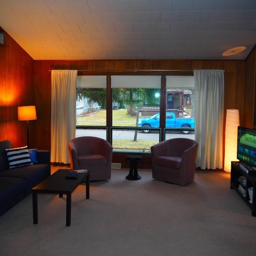 Living room:  very comfortable living room with great natural lighting, a sofa, comfy chairs, and live streaming television.