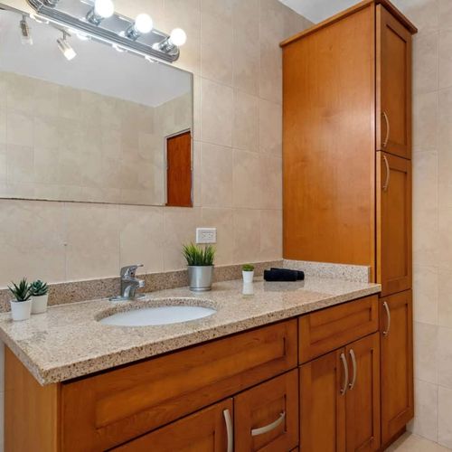 Step into a bright, clean bathroom with modern amenities and warm lighting, ensuring your comfort and convenience.