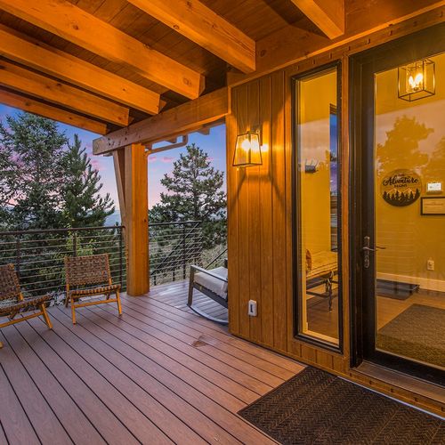 - watch the sky change colors from this peaceful covered deck with soft lighting
- perfect for sipping wine or reading a book as the day winds down
- surrounded by trees and timber accents, this is mountain magic at golden hour