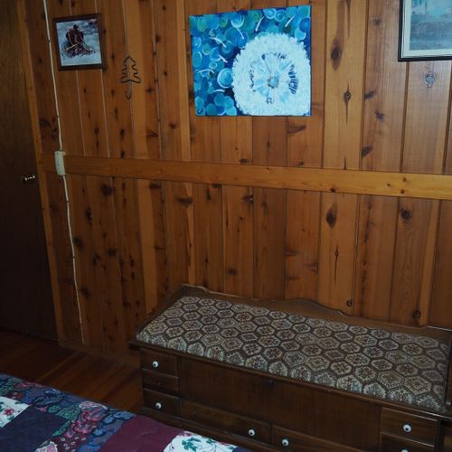 Bedroom #2 (main floor):  features a queen-size bed, nightstand with a lamp, a dresser, and a closet.