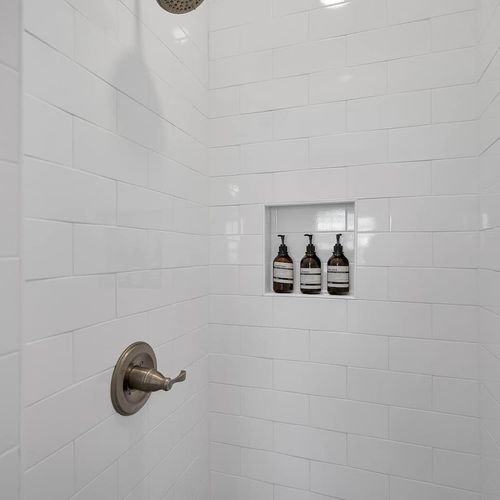 Second bathroom w/ shower & toiletries hook for a convenient, organized space.