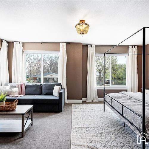 Relax in comfort in this master bedroom oasis with a king-size bed, sitting area, and private bathroom.