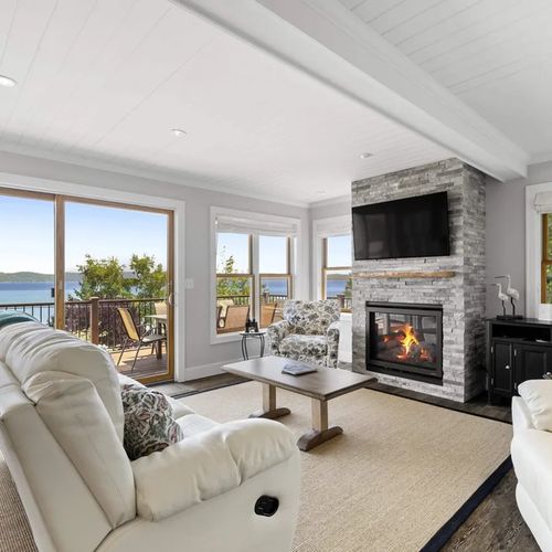 LIVING ROOM (MAIN FLOOR):  The home has a stunning living room with a spectacular view of Crystal Lake and a natural gas fireplace