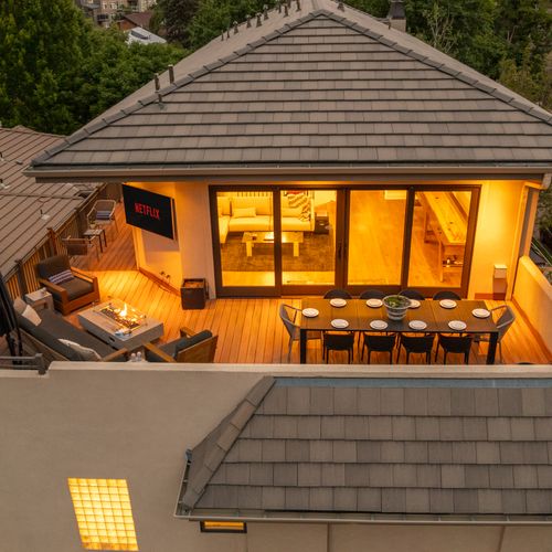 Slide open the doors and step into a fully integrated terrace experience—complete with cozy seating, a dining table, and a mounted tv for the ultimate entertainment zone.