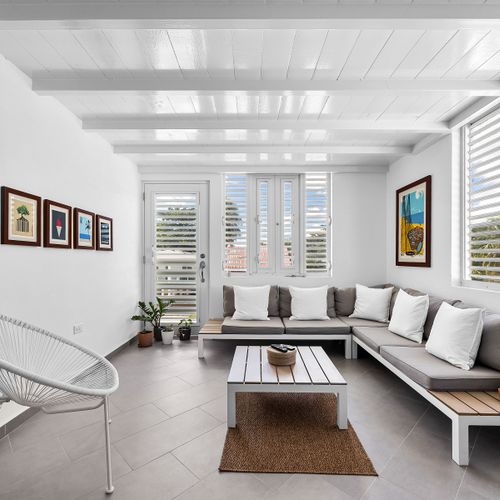 Relax in the inviting living space, complete with a comfy sofa and a bright window that fills the room with daylight – perfect for reading, lounging, or streaming your favorite shows.