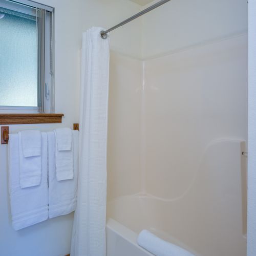 Master Bathroom with shower/tub combo. Natural shampoo, conditioner, soap, and quality towels are provided.