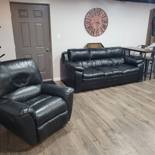 LOWER LEVEL:  Fully finished lower level with multiple sofas, multiple televisions, a foosball table, dartboard, and an air hockey table.