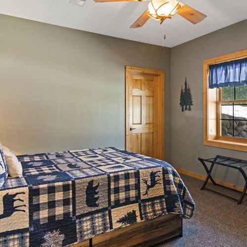 Bedroom #3 (lower level):  features a full-size bed, chair, and closet.