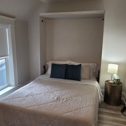 Bedroom #3 (second floor):  features a queen-size murphy bed, window a/c unit, ceiling fan, desk with chair, comfy chair, and a closet.
