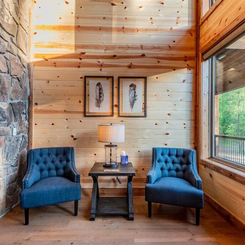 Two comfy chairs nestled in the corner of the room for great views outside.
