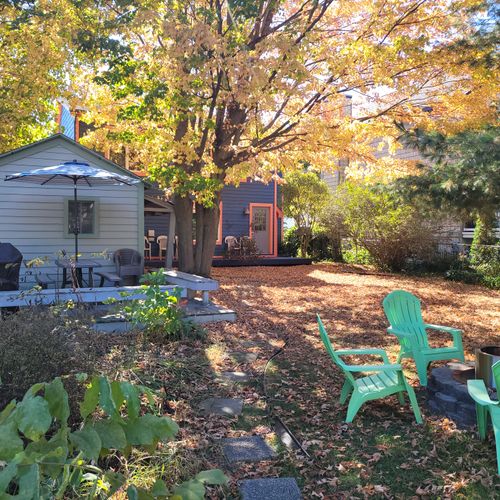 EXTERIOR:  The large and family-friendly backyard with back porch, propane grill, outdoor dining, lawn games, and a "smokeless" bonfire ring.