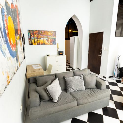 Unwind in the spacious living area, featuring comfortable seating and a lively checkered floor that adds a unique touch of personality. This inviting space is perfect for relaxing after a day of adventures.