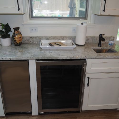 Kitchen:  a beverage cooler, mini-refrigerator, and second sink are also provided.