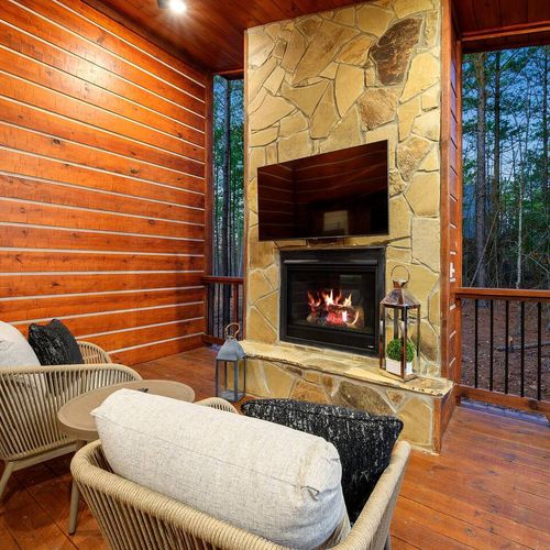 The third gas fireplace can also be found outside with luxury lounging chairs!