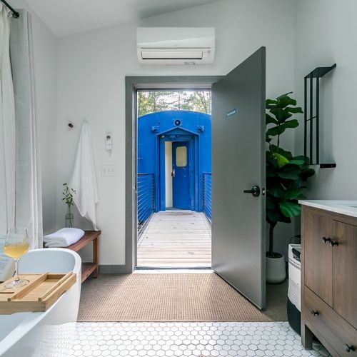 The Bathhouse is located in a separate structure outside of train car, with separate entrance.