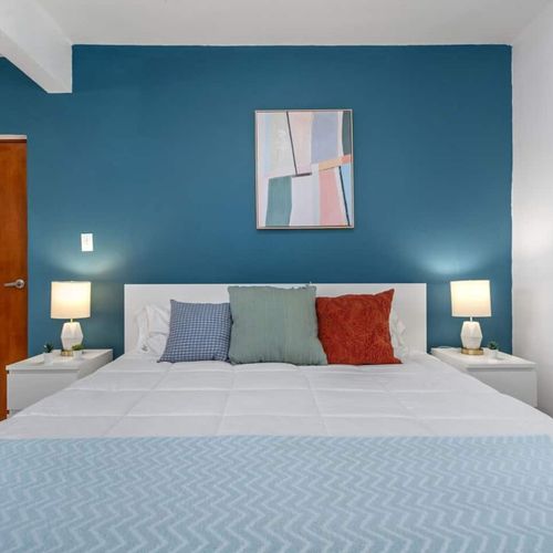 The minimalist design features a cozy bed, perfect for sinking into after a day of exploration.