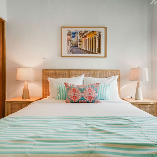 A modern bedroom with artistic decorations and a comfortable bed.