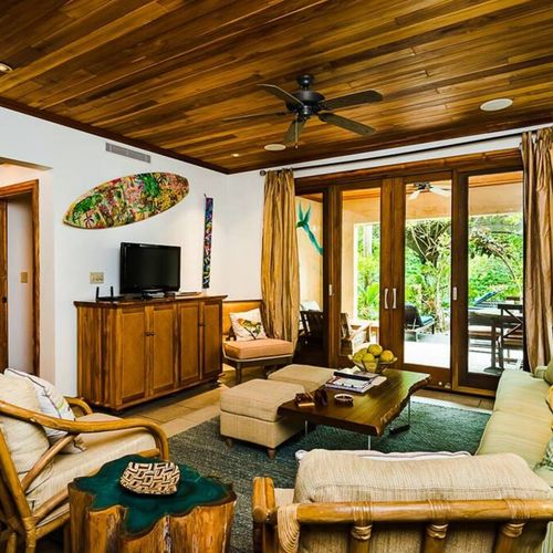 The living area includes a flat-screen TV with a cable signal.