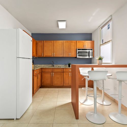 Cook with confidence! Our well-equipped kitchen features beautiful wooden cabinets and modern appliances, ready for all your culinary needs.