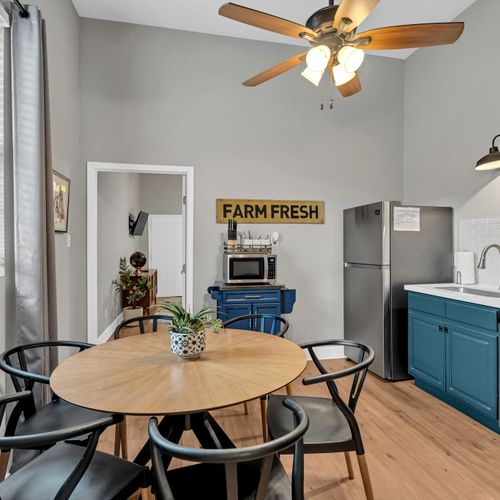 Sunny kitchen nook w/ a round table — perfect for morning coffee or a casual meal.