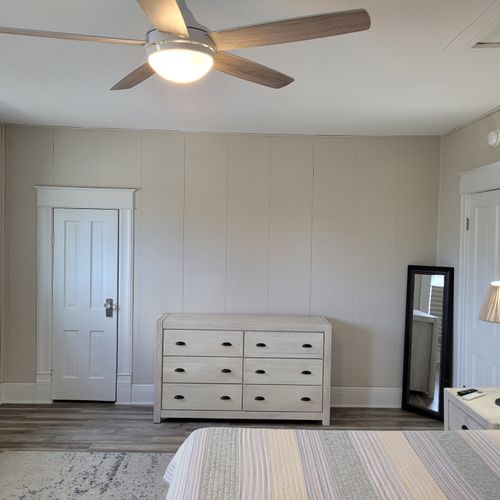 Bedroom #2 (second floor):  huge upstairs bedroom with a king-size bed, nightstands, lamps, 2 dressers, private television with live streaming, mini-split a/c unit, ceiling fan, desk with chair, comfy chairs, and a closet.