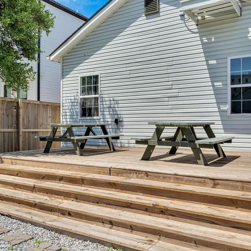 Sunny backyard deck w/ a picnic table — a great spot to dine or relax outdoors.