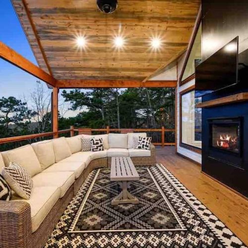 The upper level outdoor patio has an oversized sectional and gas fireplace!
