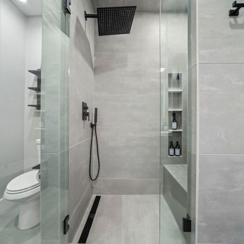Spotless bathroom with walk-in shower with clean white finishes and a spa-like feel.