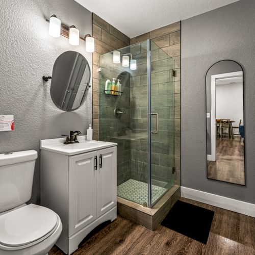 Get ready in style with a full-size mirror and a serene, minimalist bathroom design.