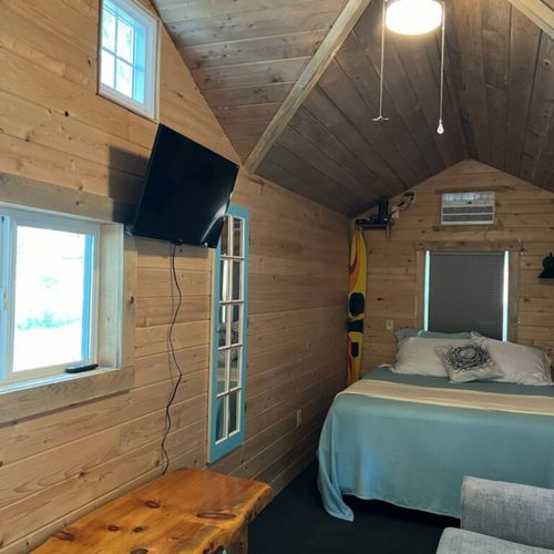Living area:  the queen-size bed and living area, highlighting the new television.