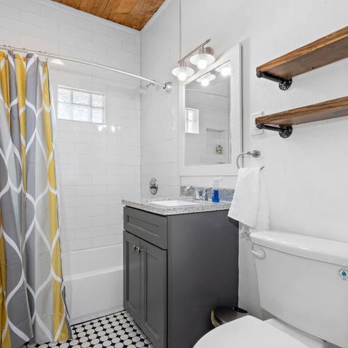 Bathtub and shower combo in the main house between bedroom #1 and bedroom #2