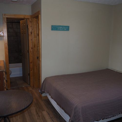 Main room:  includes a full-size bed, table, and small sink / kitchenette.