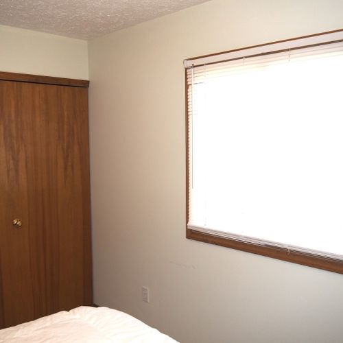 Bedroom #1 (main floor):  features a queen-size bed and a dresser.
