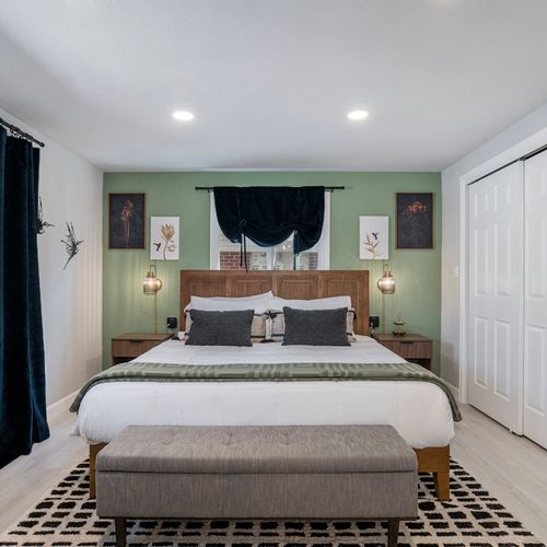 This tranquil primary bedroom features soothing tones and stylish decor, creating a serene retreat. Enjoy comfort and relaxation with a plush bed, ample natural light, and a peaceful ambiance for restful nights.