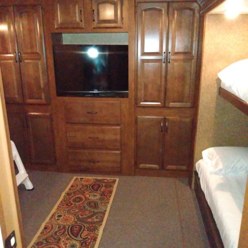 Bedroom #2:  includes 3 twin beds, a dresser, and a television.