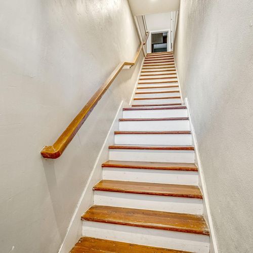 Classic wooden staircase leading up to the 2nd floor of the home.