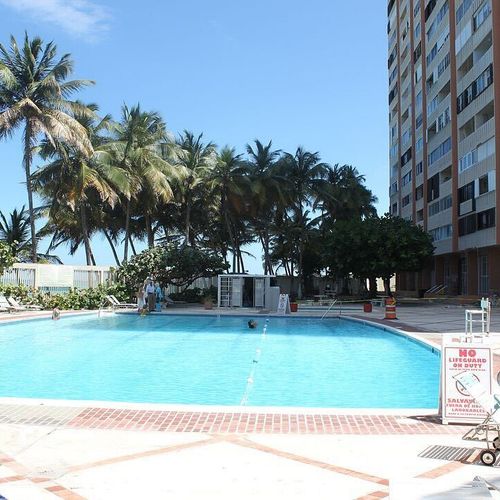 Relax poolside under swaying palms with direct access to the beach—your tropical escape awaits.