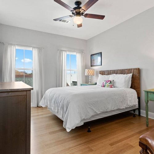 Bright, airy bedroom w/ a cozy bed & plenty of natural light.