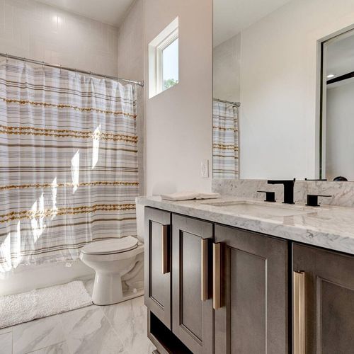 Jack & Jill bath w/ generous counter & cabinet space — perfect for sharing.