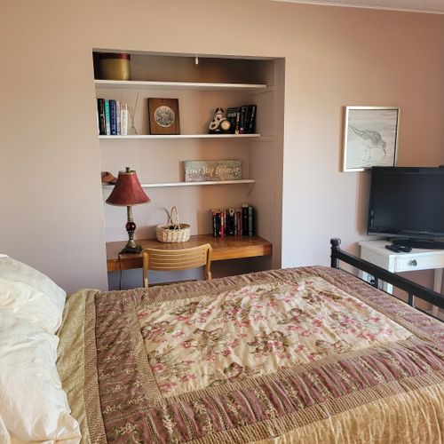 Bedroom #2 (first floor):  features a full-size bed, two closets, television, private entrance, and a great view of crystal lake!