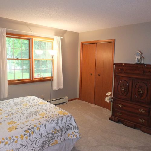 Bedroom #1:  features a queen-size bed, chair, nightstand, lamp, dresser, and 2 closets.