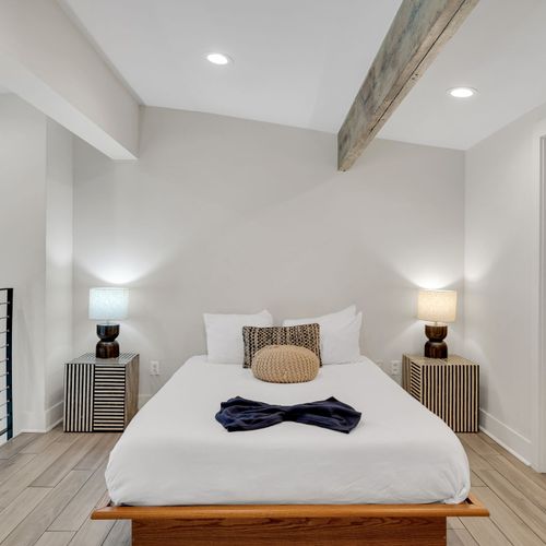 Sunlit loft bedroom where morning light spills in for a bright, airy wake-up.