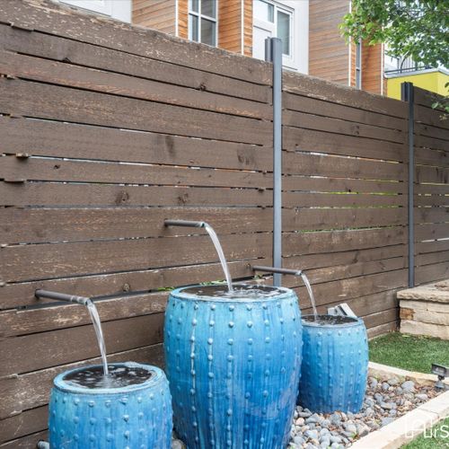 A soothing water feature in the backyard adds a tranquil and calming element to the outdoor space.
