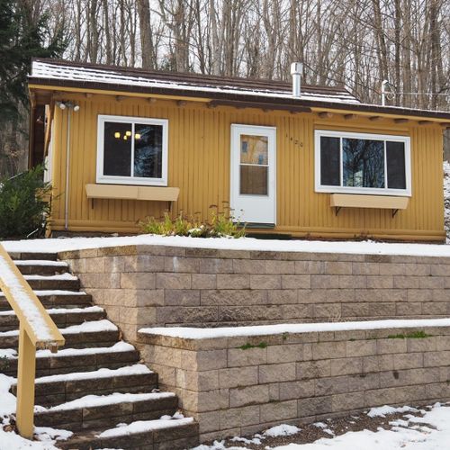 Overall:  the outside of the cabin in the winter.