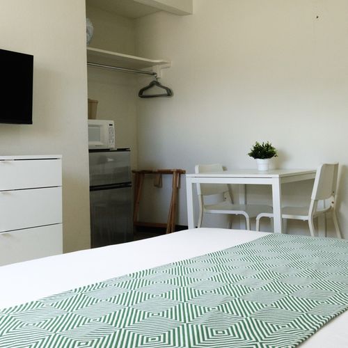 Enjoy the convenience of a studio setup, featuring a cozy sleeping area, a functional dining table for meals or work, and ample space for a comfortable stay.