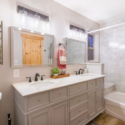 The newly-updated ensuite bathroom features dual vanities with lots of storage and counter space