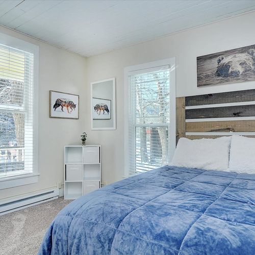 - dual windows bring in abundant sunlight and offer views of the snowy outdoors
- nature artwork and a bear themed centerpiece blend rustic charm with serenity
- clean lines, cozy textures, and thoughtful touches make for a calming retreat